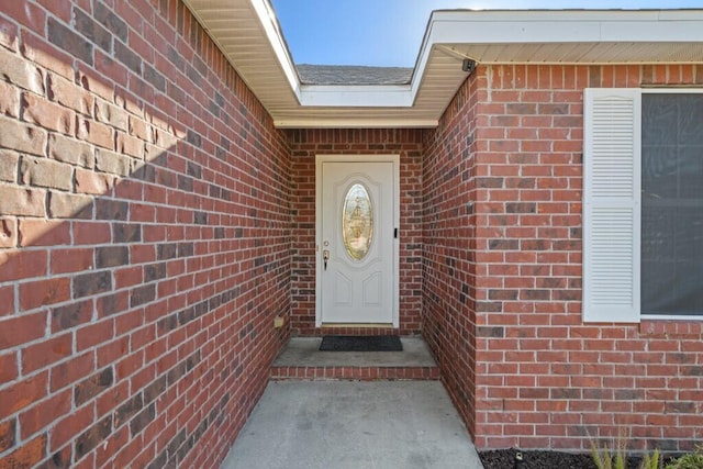 property entrance featuring brick siding