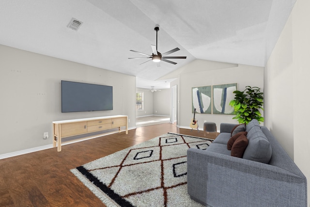 living area with lofted ceiling, wood finished floors, visible vents, baseboards, and a ceiling fan