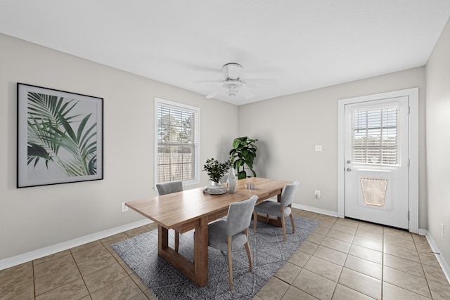 dining space with light tile patterned floors, ceiling fan, and baseboards