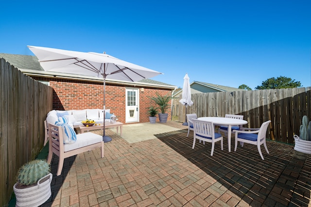 view of patio / terrace featuring outdoor dining area, a fenced backyard, and an outdoor living space