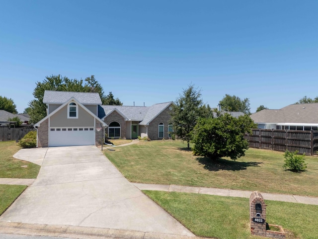 view of front of house featuring concrete driveway, a front lawn, and fence