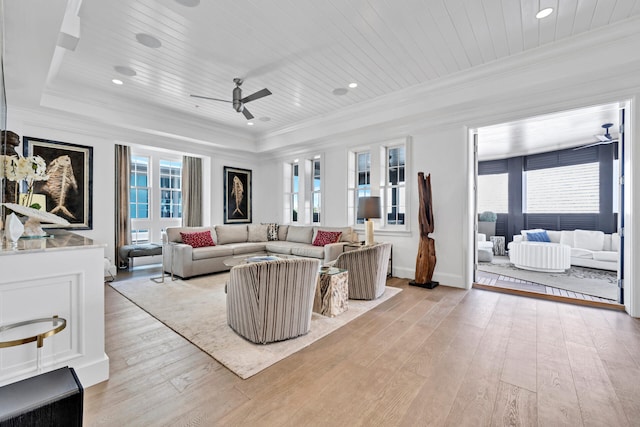 living room featuring wooden ceiling, light wood-style floors, a ceiling fan, and crown molding