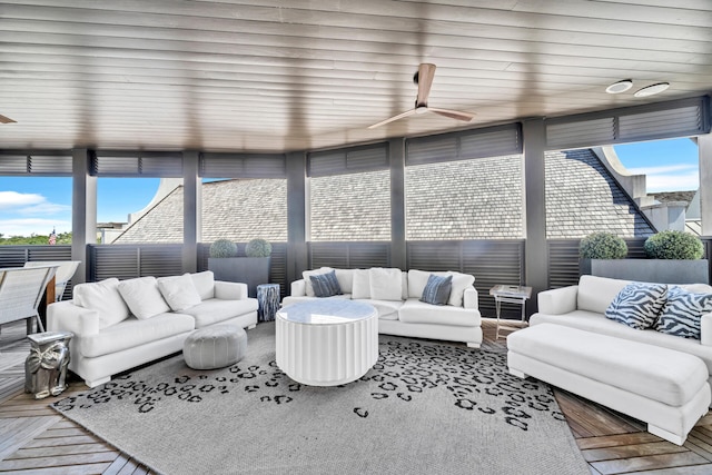 sunroom / solarium featuring a ceiling fan