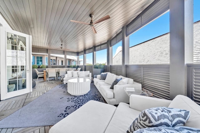 sunroom with wooden ceiling and ceiling fan