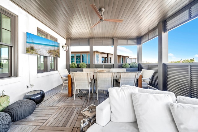 wooden terrace featuring an outdoor living space, a ceiling fan, and outdoor dining space