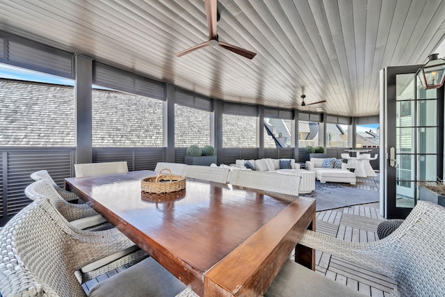 sunroom featuring ceiling fan