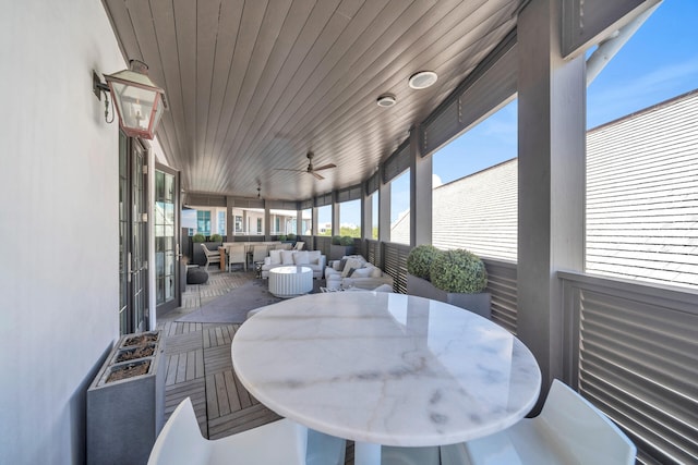 sunroom with wood ceiling and ceiling fan