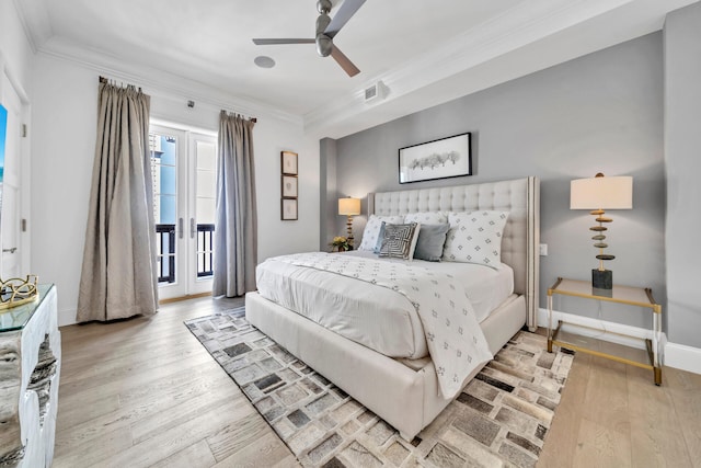 bedroom featuring access to exterior, wood finished floors, visible vents, and crown molding