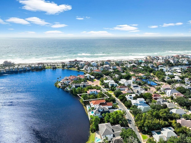 birds eye view of property with a water view and a residential view