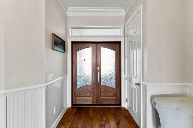 doorway with wainscoting, a healthy amount of sunlight, and crown molding