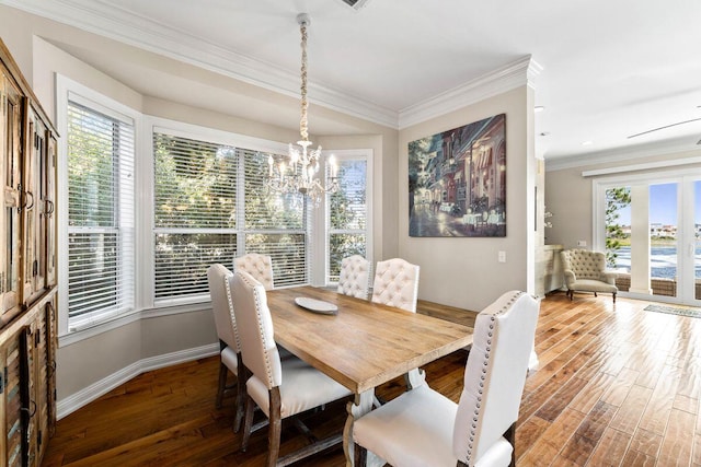 dining space with ornamental molding, baseboards, an inviting chandelier, and wood finished floors