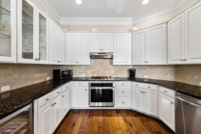 kitchen featuring white cabinets, wine cooler, stainless steel appliances, crown molding, and under cabinet range hood