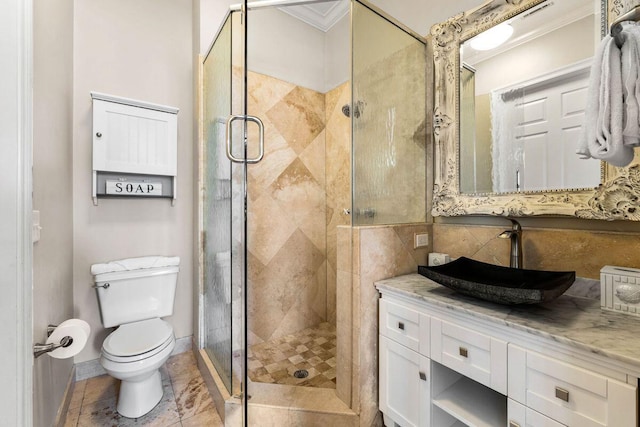 full bath featuring ornamental molding, a stall shower, vanity, and toilet