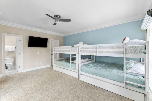 bedroom with ensuite bathroom, carpet flooring, a ceiling fan, baseboards, and crown molding