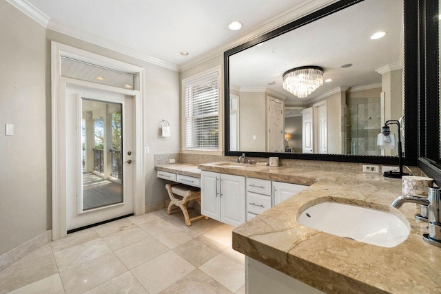 bathroom featuring double vanity, a stall shower, a sink, and crown molding