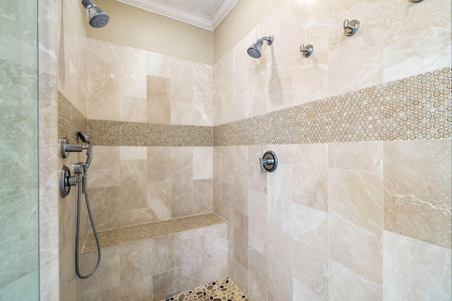 bathroom with a tile shower and crown molding