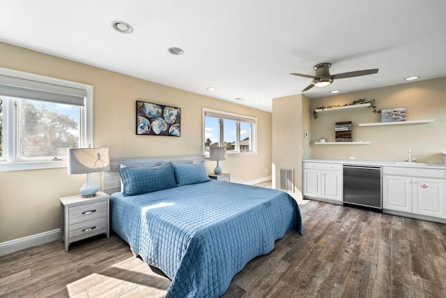 bedroom with recessed lighting, wood finished floors, visible vents, baseboards, and indoor wet bar