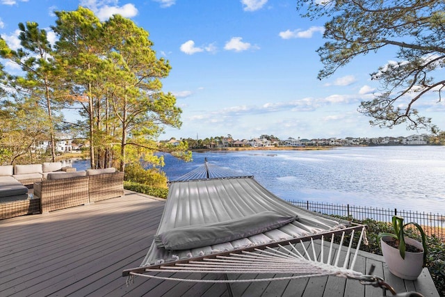 wooden terrace featuring a water view and an outdoor hangout area