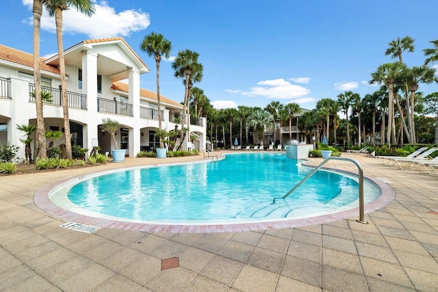 community pool with a patio area