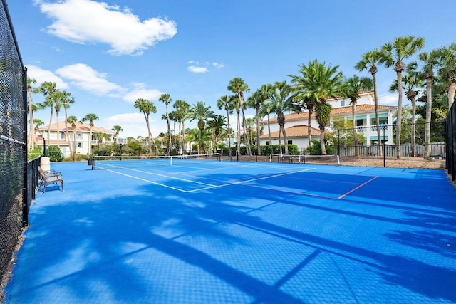 view of sport court featuring fence