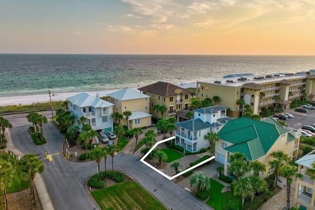 aerial view with a water view, a residential view, and a view of the beach