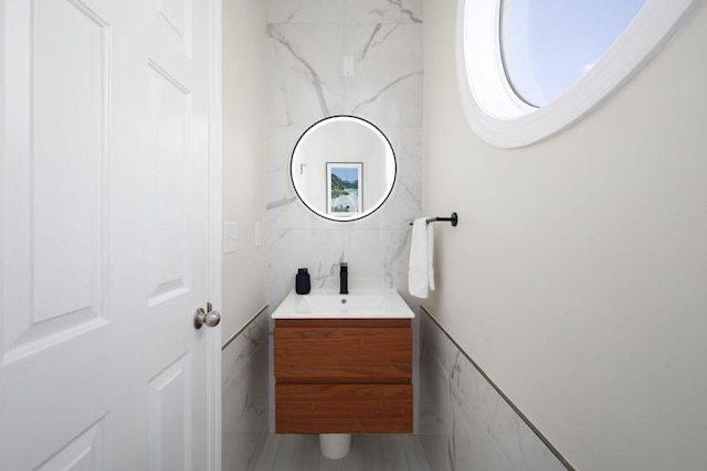 bathroom featuring tile walls and vanity