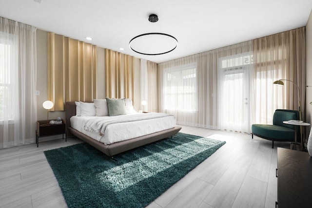 bedroom featuring wallpapered walls and wood finished floors