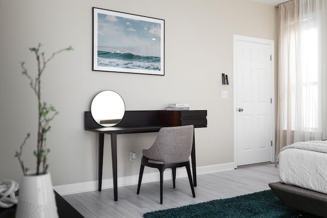 bedroom featuring baseboards and wood finished floors