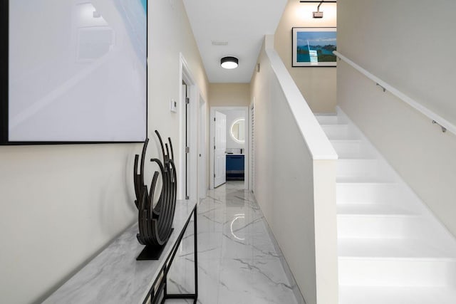 corridor featuring marble finish floor