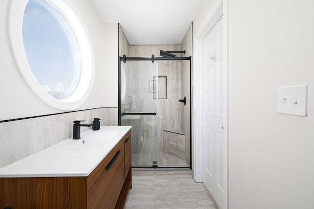 bathroom featuring a stall shower and vanity