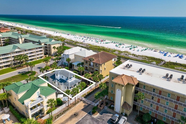 drone / aerial view with a beach view and a water view