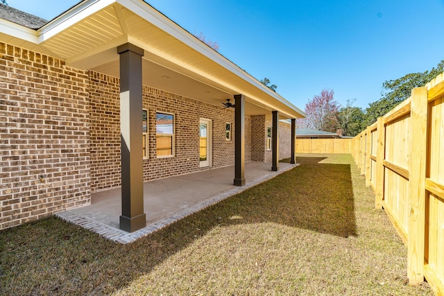 view of patio with a fenced backyard and a ceiling fan