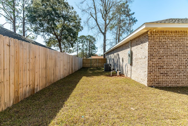 view of yard featuring central AC and a fenced backyard