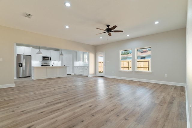 unfurnished living room with light wood-type flooring, recessed lighting, visible vents, and ceiling fan