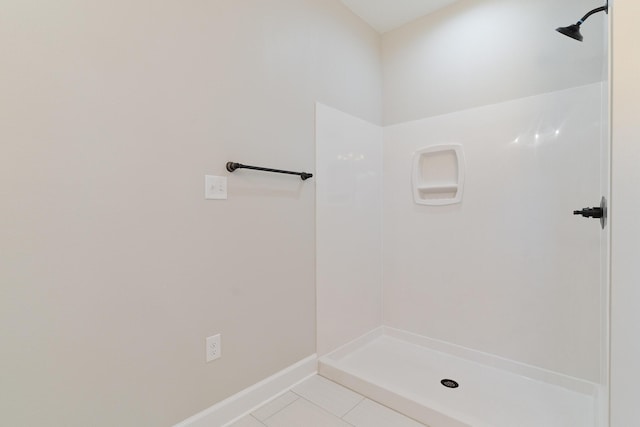 full bath with baseboards, a shower, and tile patterned floors