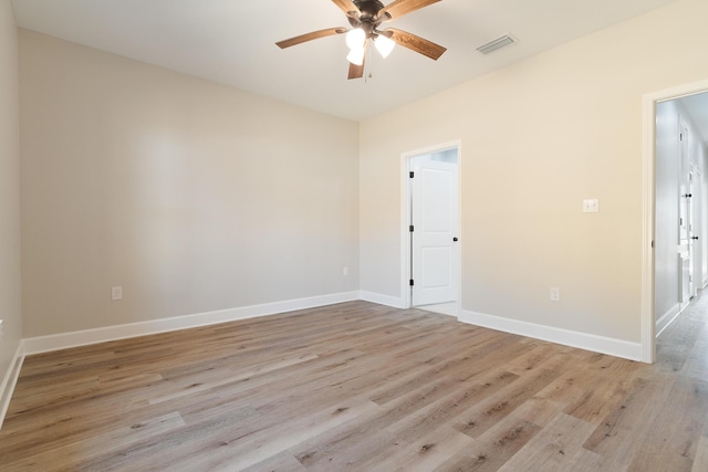 unfurnished room featuring light wood-type flooring, baseboards, visible vents, and a ceiling fan