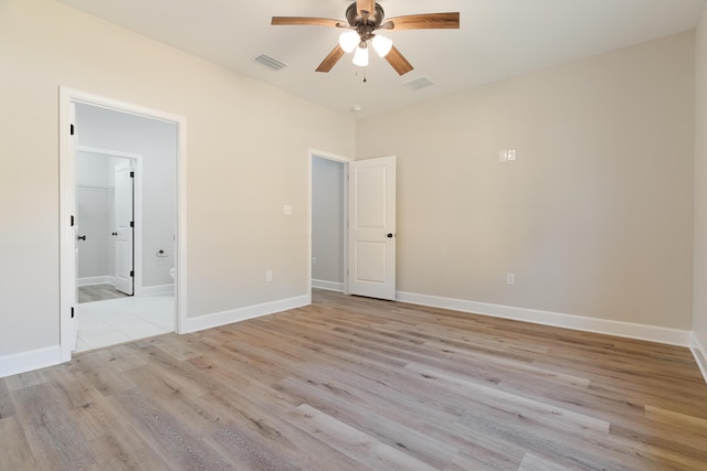 unfurnished bedroom featuring light wood-style floors, baseboards, and visible vents