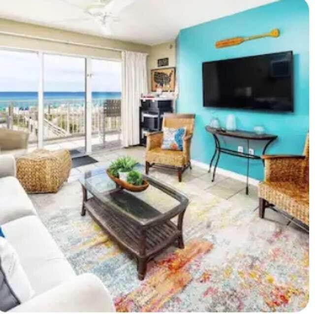 living room featuring a water view and baseboards