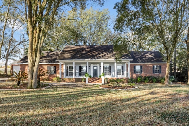 new england style home featuring a front lawn and brick siding