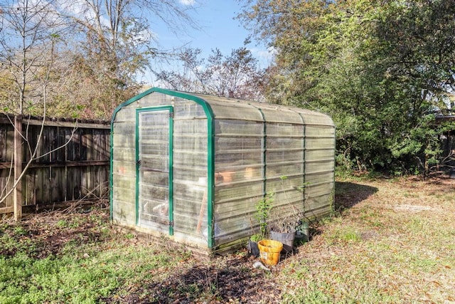 view of greenhouse with fence