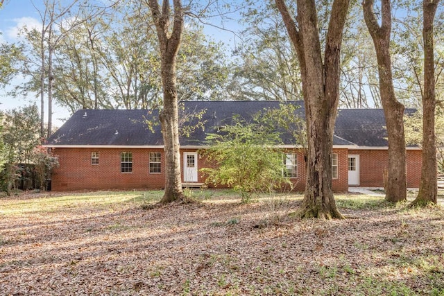 rear view of property featuring brick siding