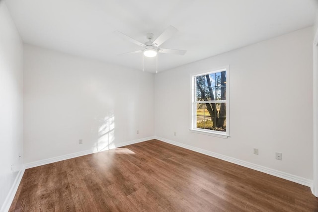 unfurnished room with ceiling fan, baseboards, and wood finished floors