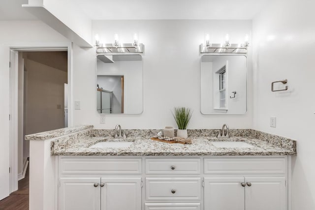 full bath featuring double vanity and a sink