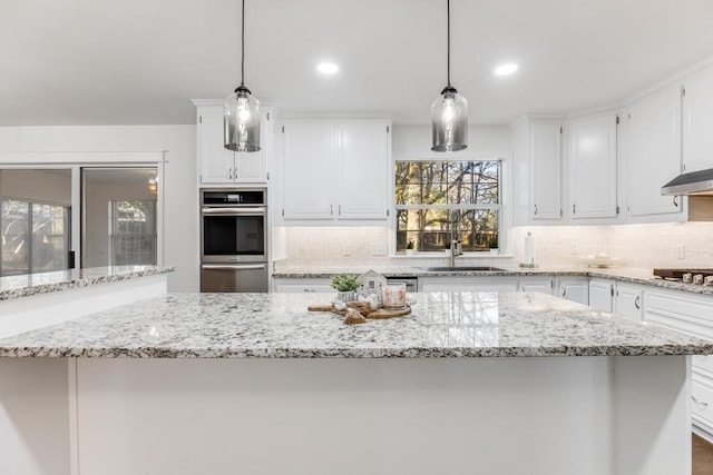 kitchen featuring white cabinets, appliances with stainless steel finishes, and a sink