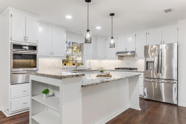 kitchen featuring visible vents, under cabinet range hood, stainless steel refrigerator with ice dispenser, a warming drawer, and open shelves