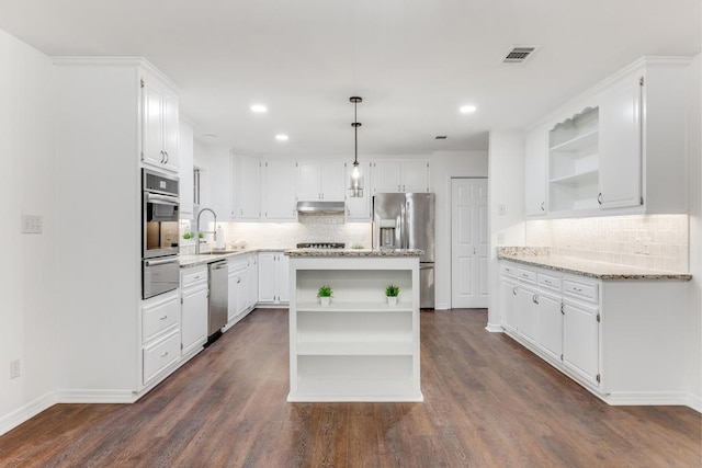 kitchen with open shelves, under cabinet range hood, stainless steel appliances, a warming drawer, and a sink