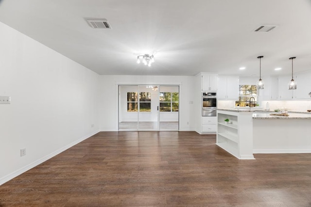 unfurnished living room with visible vents, recessed lighting, dark wood-type flooring, and baseboards