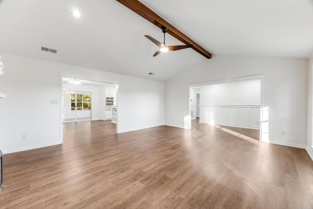 unfurnished living room with visible vents, baseboards, lofted ceiling with beams, wood finished floors, and a ceiling fan