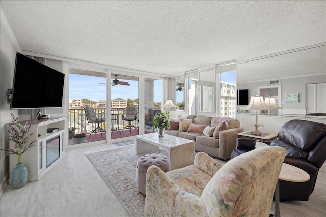 living room featuring a textured ceiling and crown molding