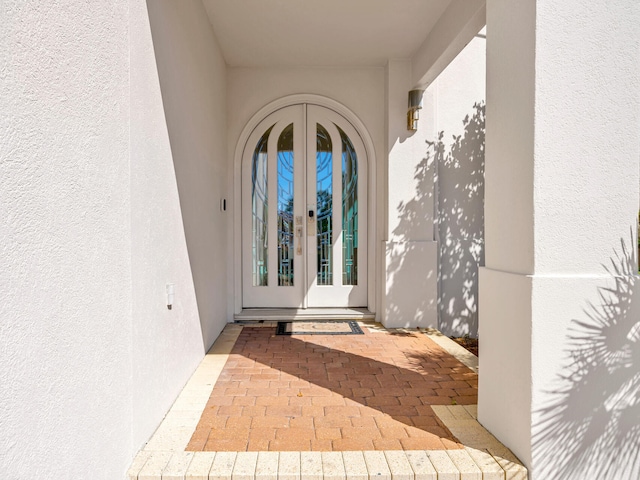 property entrance with french doors and stucco siding